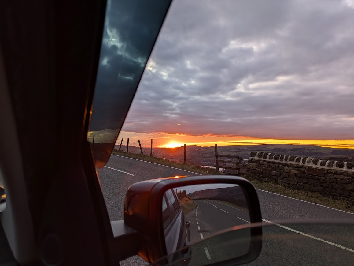 A sunset in Cornwall viewed from within the car
